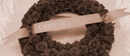 Link to funeral page. The image is a flower wreath.