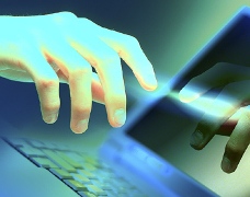 hand pointing to laptop